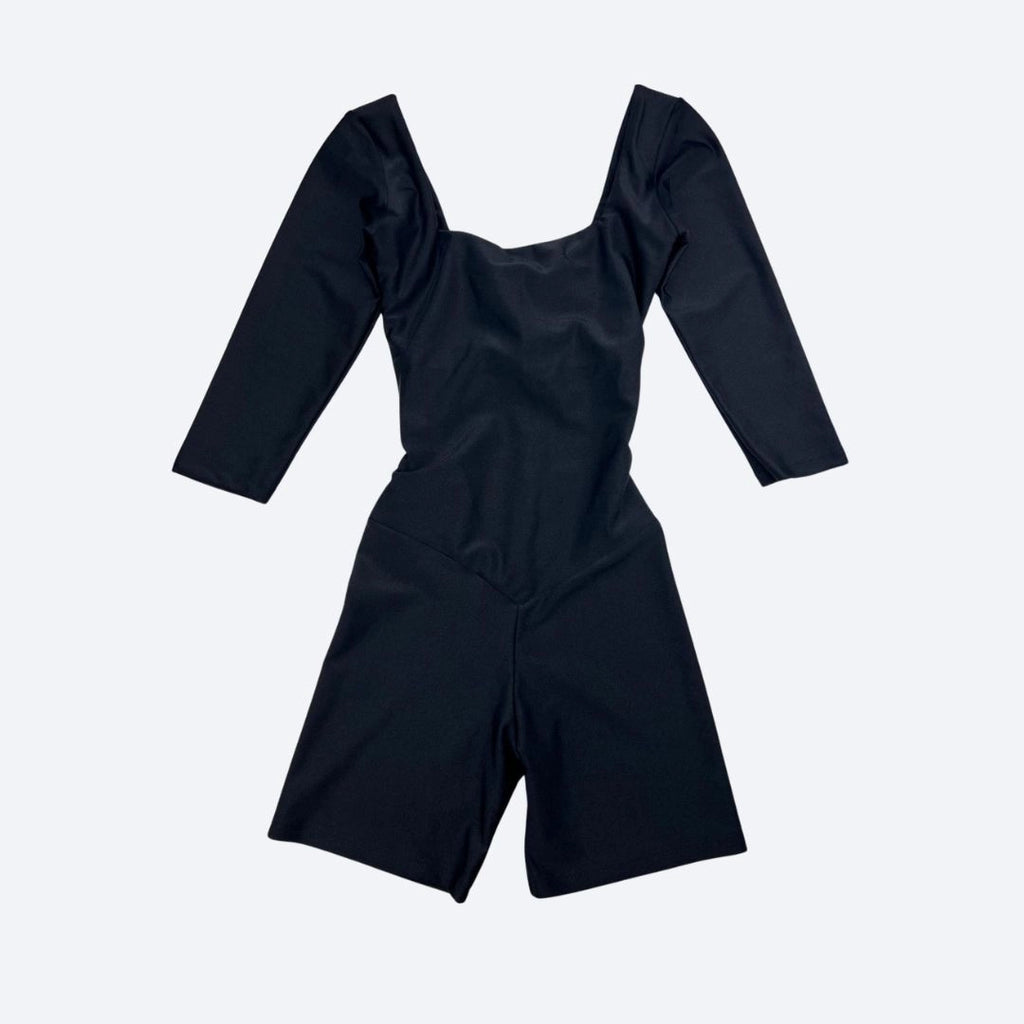 Black jumpsuit with long sleeves on a light gray background