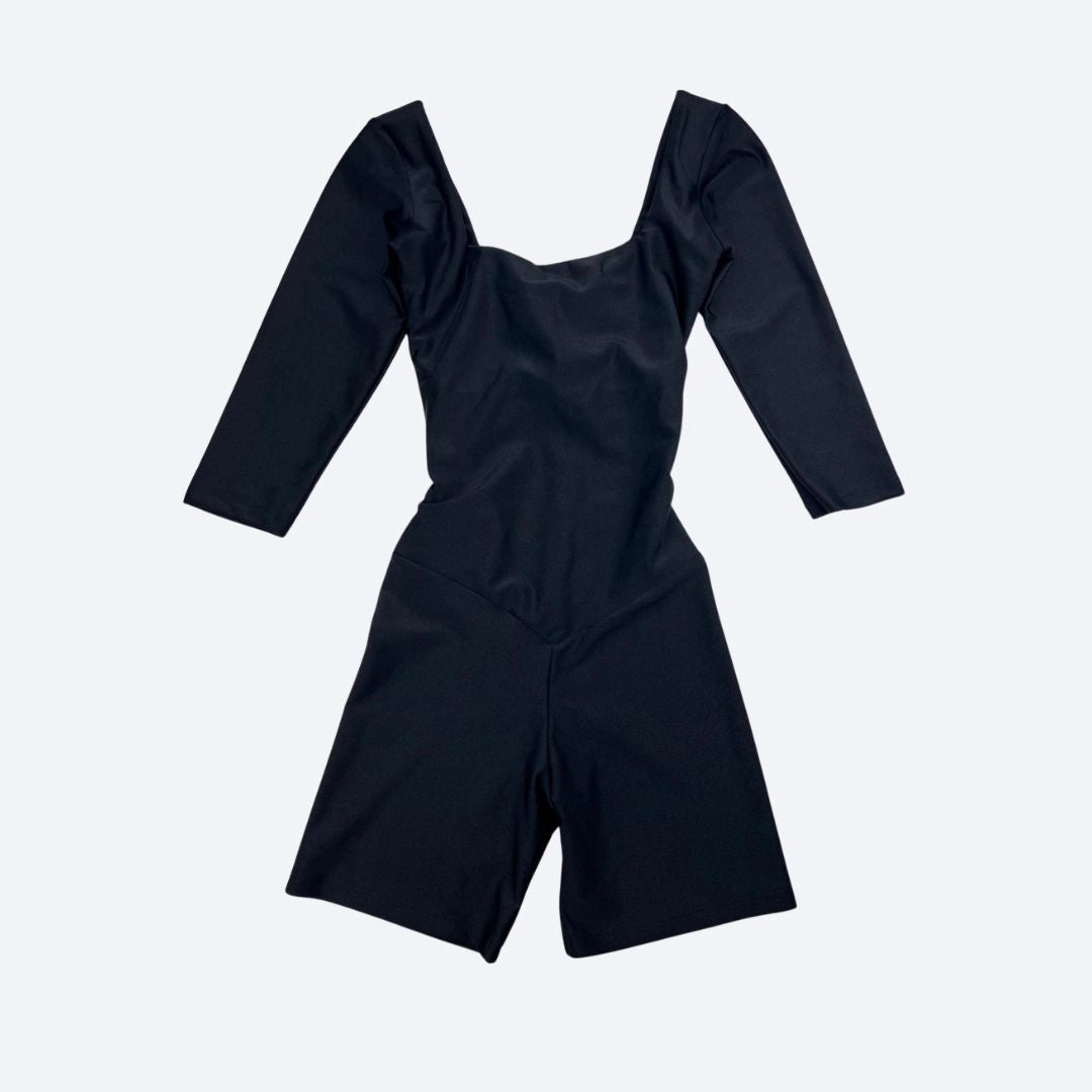 Black jumpsuit with long sleeves on a light gray background