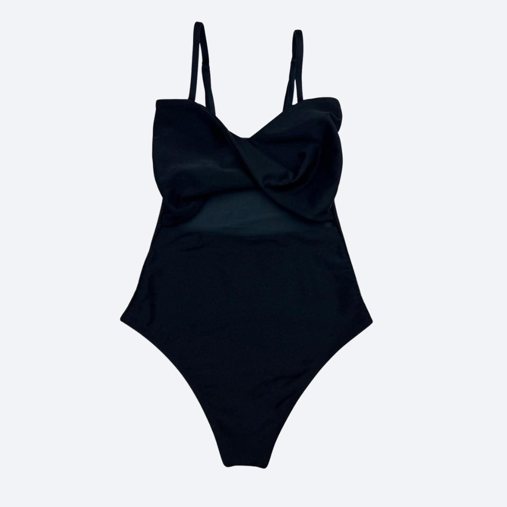 Black one-piece swimsuit and chic fitness wear with thin straps on a light gray background