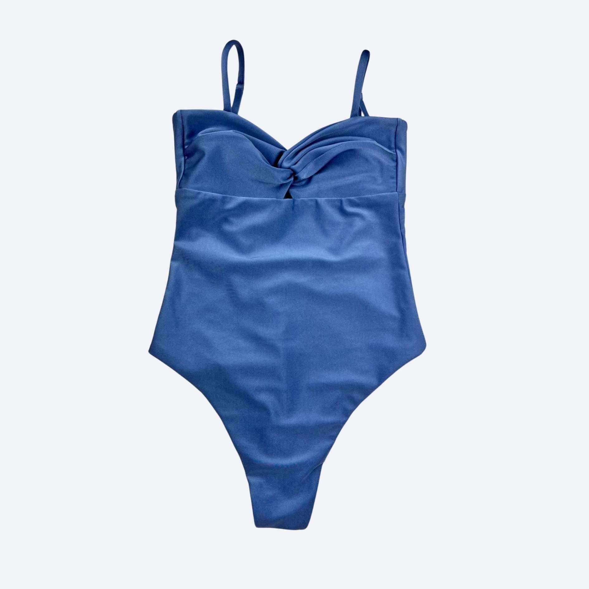 Blue women’s bodysuit with thin straps for beach or gym, displayed on a light gray background