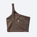 Brown sports bra with a braided handle on a light gray background