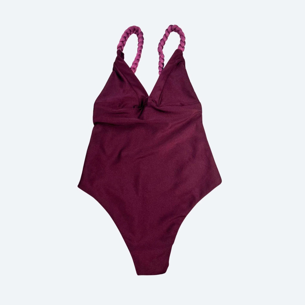 Merlot/Maroon swimsuit with braided straps on a light gray studio background