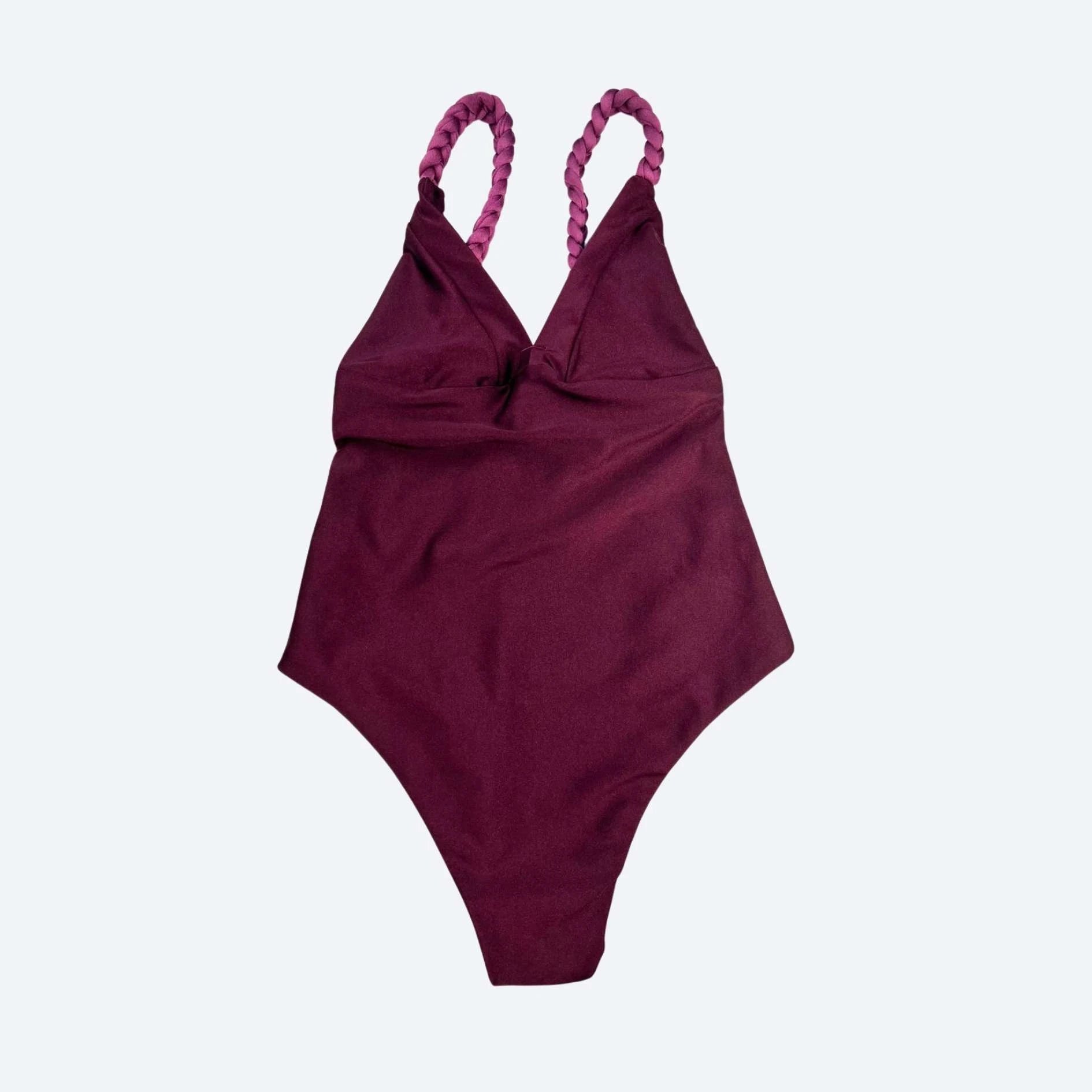 Merlot/Maroon swimsuit with braided straps on a light gray studio background