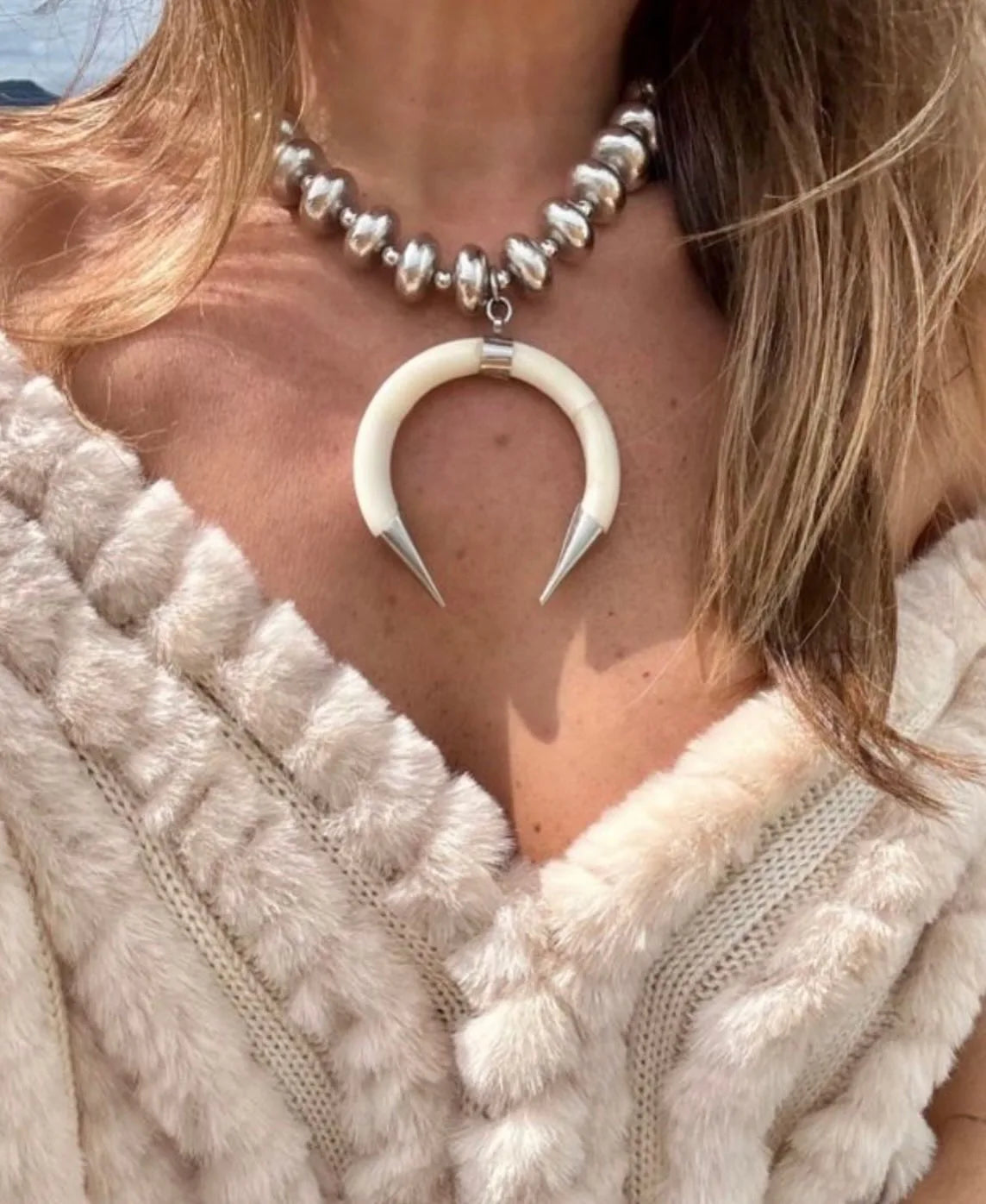Handcrafted Brazilian silver necklace for women with unique horn pendant, minimalist artisan jewelry, lightweight and versatile, perfect for resort wear, winter outfits, and everyday elegance.