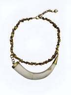 Handcrafted Brazilian necklace with horizontal horn pendant and gold-tone beads, lightweight boho chic jewelry.