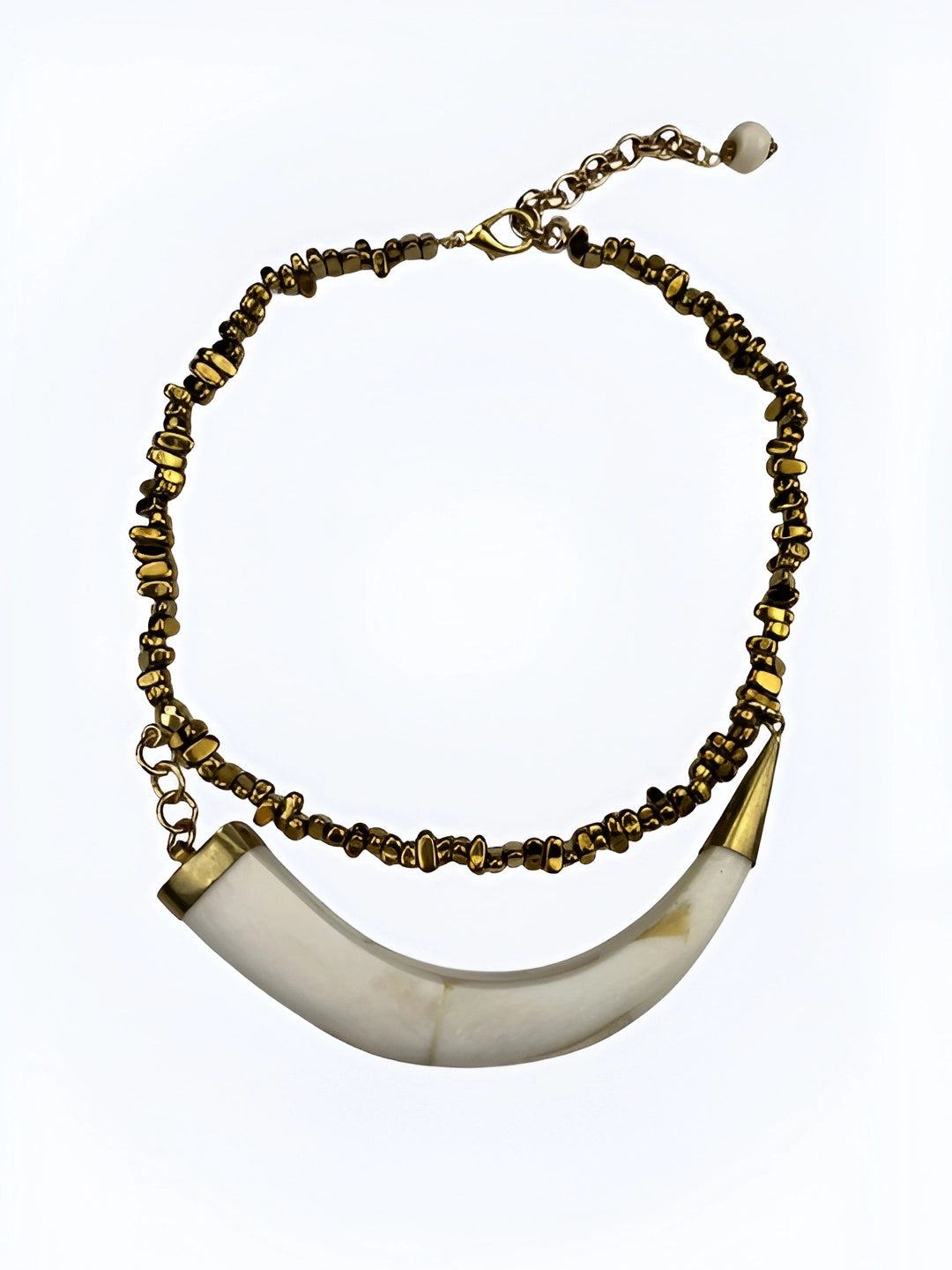 Handcrafted Brazilian necklace with horizontal horn pendant and gold-tone beads, lightweight boho chic jewelry.